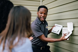 Technician showing customers a vent cover.