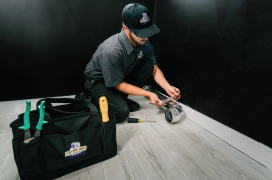 A male professional prepares for residential dryer vent duct installation.