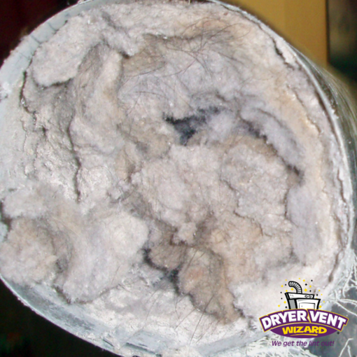 The dryer vent is completely clogged, blocking air flow and creating a dangerous fire risk.