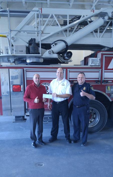Dryer Vent Wizard of the Golden Triangle presenting a cheque to the City of Kitchener - Fire Department for their work in community education about fire prevention.