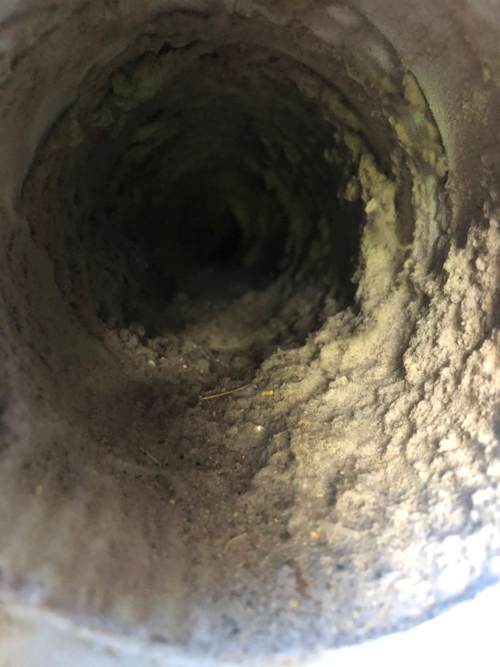 Dryer vent pipe lint build-up before cleaning in Plymouth.