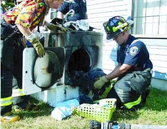 Fire fighters with a burnt dryer